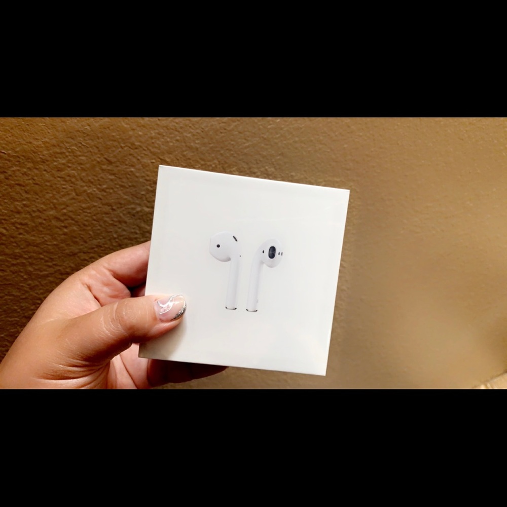 Unopened Apple AirPods with charging case